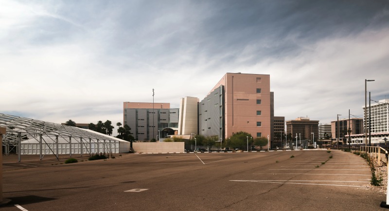 Generic office buildings and empty parking lot in American city.