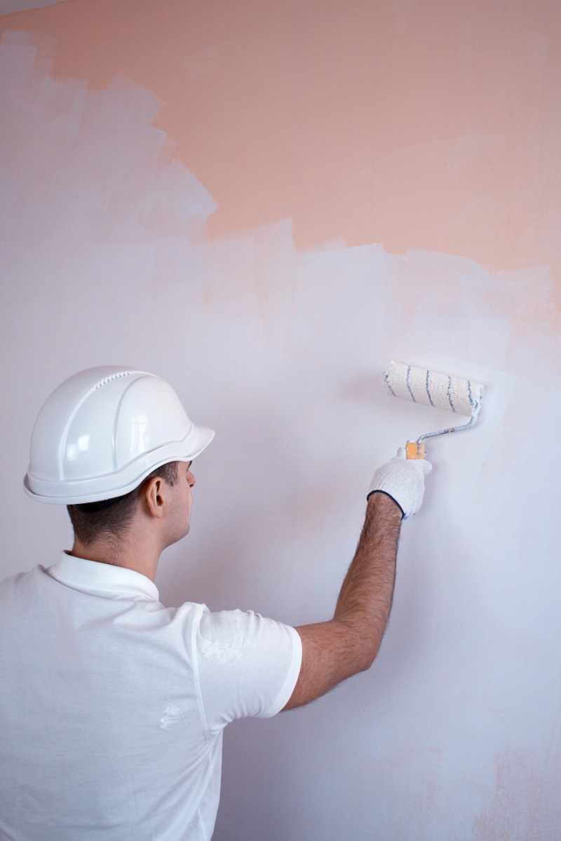 Close up view of man holding paint roller