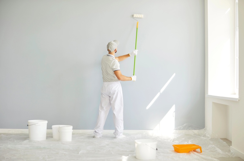Back View Building Contractor White Clothes Paint Roller Hand Painting