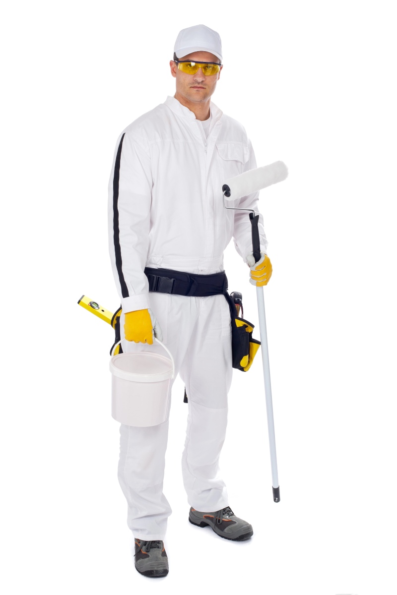 Painter in white overalls holding paint brush bucket