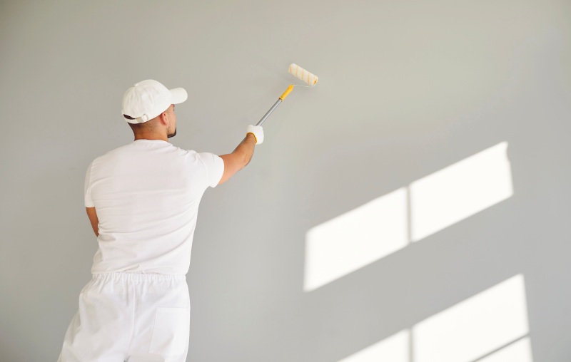 Back View Building Contractor White Clothes Paint Roller Hand Painting