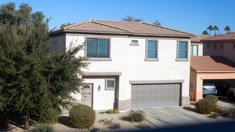 Residential Single Family Stucco House Two Levels Two Car Garage Drive