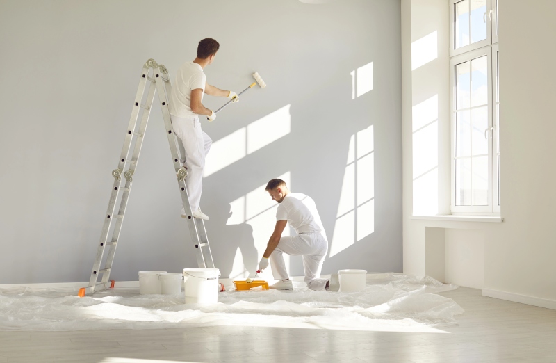 Team Professional Painters White Clothes Painting Grey Wall Empty Room